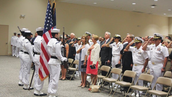 Guests say the Pledge of Allegiance at the beginning of a change of command ceremony at Naval Network Warfare on Tuesday.