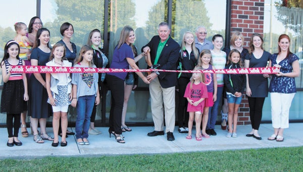 Councilman Roger Fawcett cuts the ribbon Friday to officially open an expansion of Dynamic Movements School of Performing Arts in Harbour View.