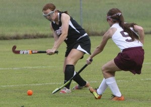 Nansemond River High School senior Amber Daubenspeck swings at the ball as King’s Fork High School sophomore Emma Marston defends on Monday. Daubenspeck scored during the game to help her team achieve a 3-1 conference road win.