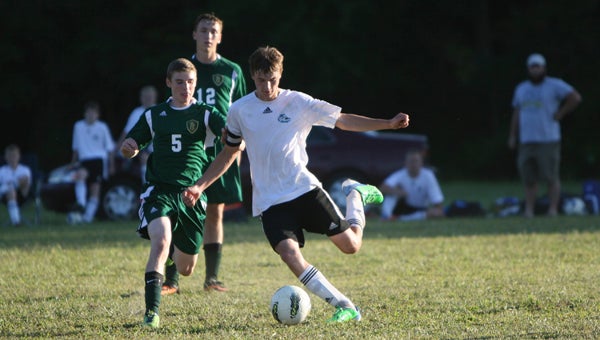 Suffolk Christian Academy senior midfielder Collin Dennys kicks the ball upfield during the Knights' 4-1 victory over visiting Gateway Christian School. Dennys iced the win with a late goal off a penalty kick.