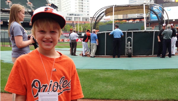 Suffolk's Parker Duke, 7, stands in Oriole Park at Camden Yards on Thursday after winning the CareFirst Adam Jones Fan Challenge, which set him up for a doughnut-eating contest with Jones, one of his favorite baseball players. Parker won the contest and later watched as Jones hit a home run, leading the Orioles to a 3-1 victory over the Chicago White Sox. (Eley Duke photo)