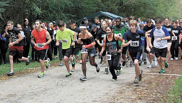 Participants in last year's inaugural Zombie Run at Lone Star Lakes Park set off on the course. This year's event is set for Oct. 20.