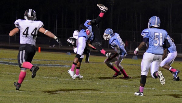Lakeland High School junior defensive back Convon’Tra Revell makes a mid-air tackle last week against Hickory High School in the Cavaliers’ first win of 2013. The Cavs’ defense will need to be quick to the ball tonight against visiting Western Branch High School.