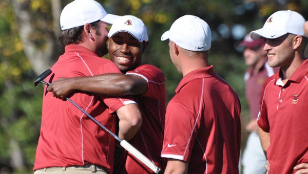 Suffolk’s Ben Hunter is congratulated by his teammates from the Apprentice School on Tuesday after winning the second USCAA Individual National Championship of his career. He birdied a one-hole playoff for the win on the Penn State Blue Course in State College, Pa.