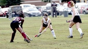 Nansemond River High School sophomore forward Natalie White looks to play keep away from the Heritage High School player on Wednesday evening as sophomore forward/midfielder Ashley Hiltabrand comes to provide support. The Lady Warriors won at home, 9-0, on Senior Night.