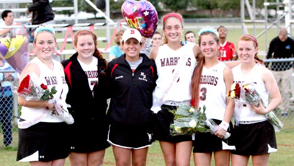Nansemond River High School head coach Ali Mowry gathers with her seniors on Senior Night after a 9-0 victory over visiting Heritage High School in which all five players scored. From left: goalkeeper Brooke Street, back Elizabeth Gover, Ali Mowry, back Madison Janek, forward Kimberly Bates and forward Amber Daubenspeck.