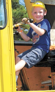 Matthew Smith, 5, tries out the controls on a piece of construction equipment at the Suffolk Nansemond Historical Society’s Touch a Truck, Train and More event on Saturday afternoon.