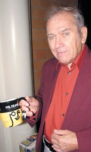 Former Planters employee Francis Elick shows off a Mr. Peanut mug he purchased at Saturday's swap meet.