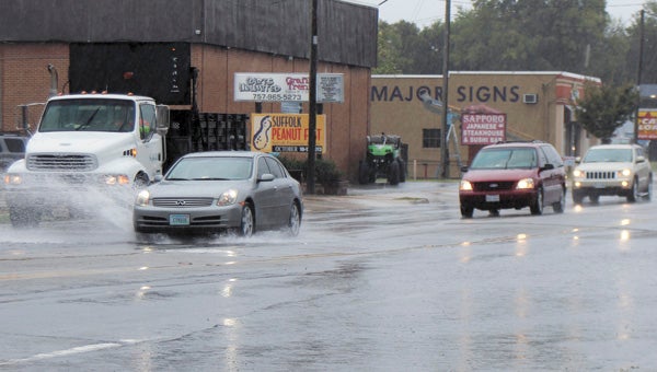 Cars trek through high water at North Main Street's Kimberly Bridge on Wednesday afternoon.