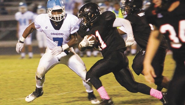 Nansemond River High School senior running back Latrell “Vegas” Sandifer races for more yardage against visiting Lakeland High School on Friday, homecoming night. Sandifer had his way against the Cavaliers defense, running for 221 yards and a touchdown in the Warriors' 31-12 win. He also had a key interception that kept momentum out of Lakeland's hands going into halftime.