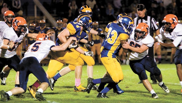 Nansemond-Suffolk Academy junior fullback David Gough looks for more yardage Friday as a Norfolk Academy defender gets a hand on the ball. The Saints ended up losing 21-16 in a controversial game on their homecoming night.