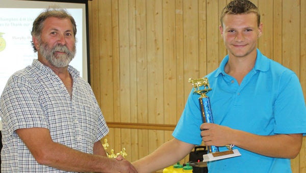 Philip Carr Jr., 15, of Carrsville, was awarded a trophy for having the Reserve Champion Heifer. He is pictured here with Walter Young III, 4-H Heifer Show Co-Chair.
