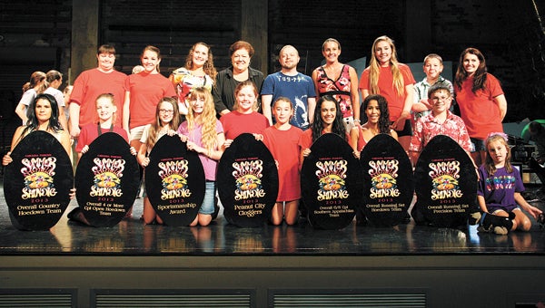 The Peanut City Cloggers show off multiple awards from a recent competition. The group includes (top row, from left) Teresa Davis, Payton Kerlee, Karley Barnes, Donna Riley, Bob Greene, Joann Bricker, Jordan West, Jakob Randall and Judi Lester; and (bottom row, from left) Lindsay Skeen, Olivia Morris, Hannah Baines, Katie Timmins, Mackenzie West, Brooke Hayden, Leia Dotson, Samantha Thomason, Harrison Storms and Reilly Price.
