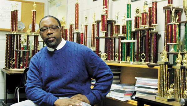 Alvin W. Wilson II, director of Lakeland High School’s Quiet Storm marching band, sits in his office amid a growing collection of trophies.