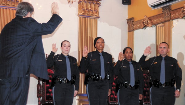 At The First Lady Thursday, Randy Carter, clerk of the Circuit Court, swears in four new Suffolk police officers: Ashley Buie, Aldonyia Brooks, Lorri Ellis and Rosario Tumminello.