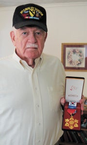 Suffolk’s Claude Huffman recently received from the South Korean government a medal honoring his service in the Korean War. The medal, crafted with a piece in its center of rusty barbed wire from the demilitarized zone between North and South Korea, is being given to the war’s combat veterans.
