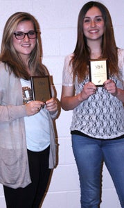 Nansemond River High School performing arts students Lauren Farrar and Savannah Miller show the awards they recently scooped, which are among several from the decorated drama program.