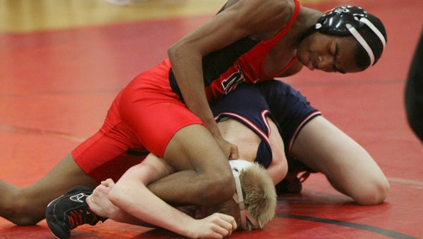 Nansemond River High School sophomore 106-pounder Malcolm Dawson puts pressure on Zach Gillette of Grassfield on Wednesday. Gillette eventually won with a pin.