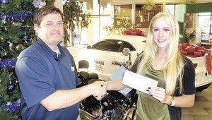 Aaron Duman presents a check on behalf of Mike Duman Auto Sales and its employees to marketing consultant Leanne Hundley for the Suffolk News-Herald Cheer Fund. To contribute to the Cheer Fund, send your check to 130 S. Saratoga St. or bring it by the Suffolk News-Herald at that address. If you bring your check in person, we are available to take your photo and publish it in the newspaper. For more information about the Cheer Fund, call 934-9616.