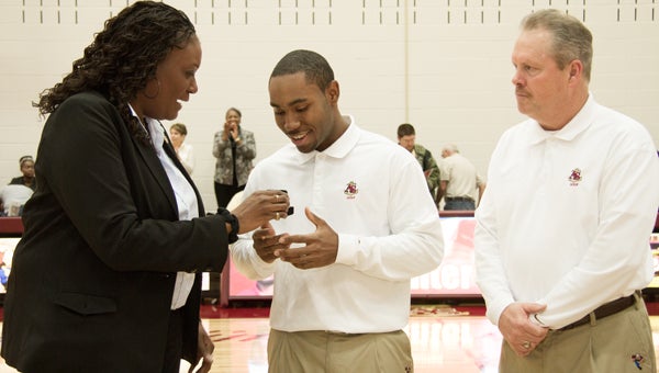 Dar Deerfield Mook/NNS Photography Repeat national champ: Suffolk's Ben Hunter receives a ring from Apprentice School athletic director Keisha Pexton, honoring his unprecedented golfing success at the school, as AS head golf coach Joey Maben looks on.