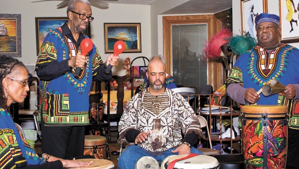 Members of the Sunset Drummers play a calypso beat. From left are Guinelle Koonce, Vivian Jack, Geoffrey Outlaw with Eleanor Jack hidden behind him, and Isaac Baker.