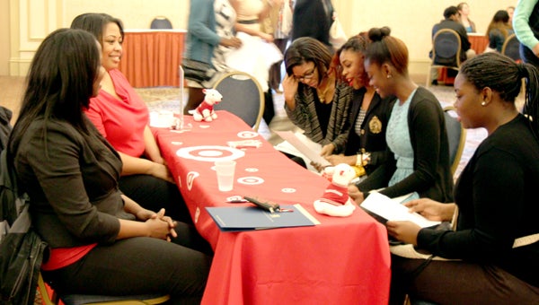 Students learned from employers about non-traditional careers during a Suffolk Public Schools event at the downtown Hilton Thursday. Jasmine Veal, Lakiaya Aponte, and sisters Cierra and Alexis Gilmore, of Lakeland High School, learned what career opportunities Target has to offer, from group leaders Teri Bomisso and Cheryl Lawton.