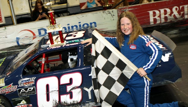 Olivia Florian celebrates with the checkered flag and her trophy following her second straight win in the 30-lap youth series race in the Arena Racing USA events on Saturday at the Richmond Coliseum.