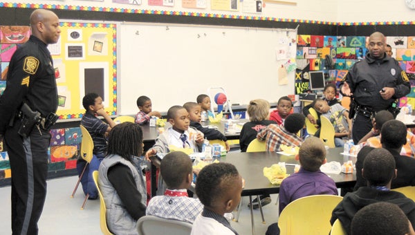 During a meeting of Creekside Elementary School’s boys-only Breakfast Club Tuesday, Suffolk police officers Andre Sparks and Robert Burton discuss the impacts of bullying and ways of avoiding bullies.