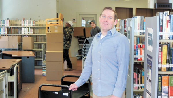 Clint Rudy, director of Suffolk Public Libraries, was at the city’s Chuckatuck library branch Friday to help move out items and furniture for a library “lift” that will include new shelves, paint and carpet. Clyde Butler and Alex Owens do some heavy lifting behind Rudy.