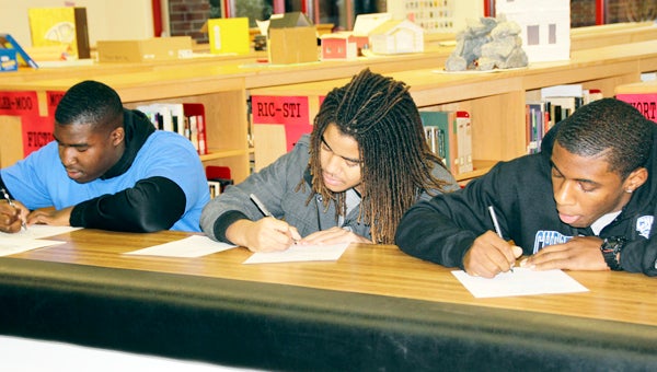 Nansemond River High School football players Tracey Parker Jr., Andre Butler and Marvin Branch participated in National Signing Day on Wednesday. (Robin Hirsch photo)