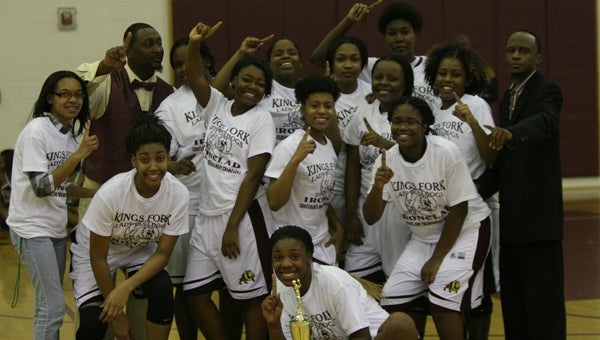 King's Fork High School's 2013-14 girls' basketball team, coaches and staff celebrate after winning the Ironclad Conference tournament on Friday.