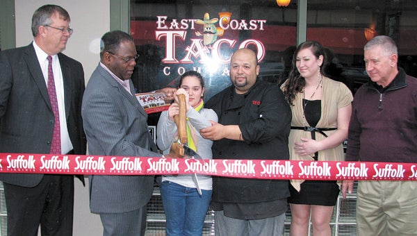 Cutting the ribbon at East Coast Taco Company on Thursday are, from left, Councilman Charles Parr, Vice Mayor Charles Brown, Isabelle Moncada, her father Jose Moncada (the owner), manager Jackie Nilo and Councilman Roger Fawcett.