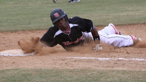 Nansemond River High School sophomore Dion Jordan dives back to second when a Grassfield High School pitcher kept him honest on Saturday. The Warriors won 4-3 in nine innings.