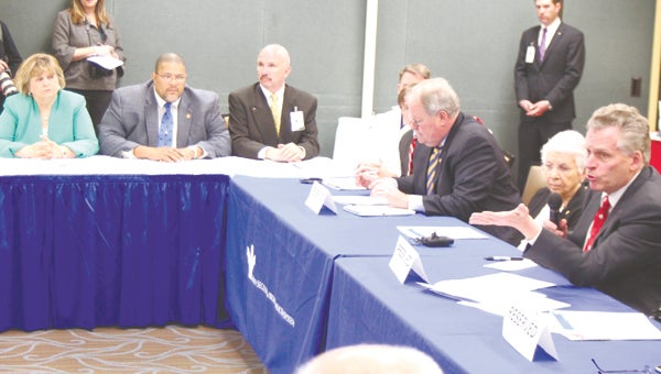 At Bon Secours Maryview Medical Center in Portsmouth on Monday, Suffolk Mayor Linda T. Johnson, seated far left beside Portsmouth Mayor Kenneth Wright, listens to Gov. Terry McAuliffe — seated far right — argue to expand Medicaid in Virginia.