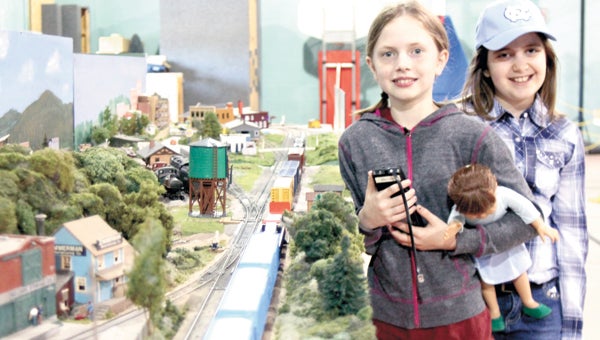 Emma Cox, 11, and Mia Rodriguez, 8, become train drivers — for a brief moment in time — during a model train expo at Wilroy Baptist Church on Saturday.