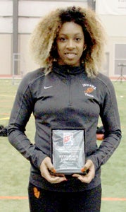 Sophomore Malika Rashid, a former Nansemond River High School track athlete, holds her award for placing sixth in the long jump at the NAIA indoor national championships.