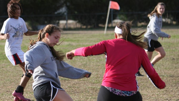 King’s Fork High School junior Rachel Gist, left, tries to get past fellow team captain, senior Maiah Wright, at practice on Friday. 