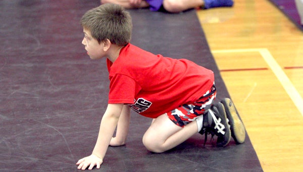 First grade 56-pounder Joshua McMillan has gotten an early start in the sport as members of the Warrior Youth Wrestling Club.