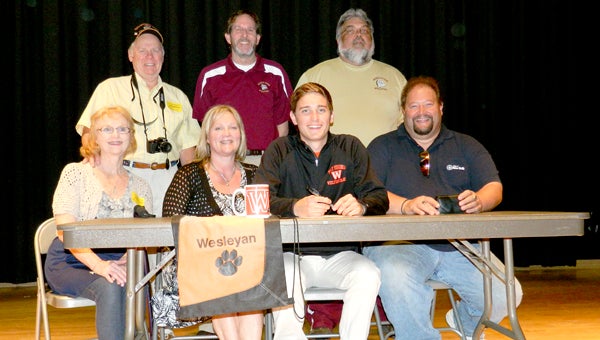 King's Fork High School's Hunter Lowe signed to swim for West Virginia Wesleyan College at a Monday ceremony with family and coaches. Front row, from left: Dorothy Cogswell, Elizabeth Lowe, Hunter Lowe and Sydney Lowe; back row, from left: Pete Cogswell, Dan Krewson and Randy Jessee.