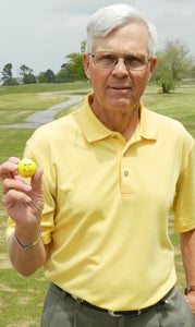 Suffolk's John Fisher holds up the ball he only hit once to find the hole on No. 2 at the Nansemond River Golf Club on Sunday.