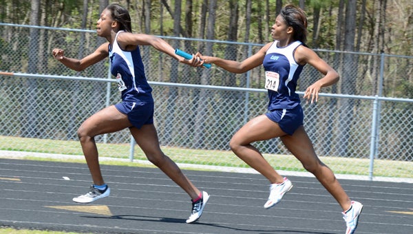 Lakeland's Teahney Walker hands off to Kiera Rountree in the 4x400-meter relay during the Atlantic Coast “Spring Break” High School Invitational this weekend at Lakeland High School. The relay team finished in fourth with a time of 4:18.96. (Melissa Glover photo)