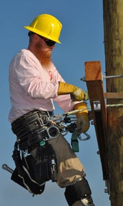 Eric Thiede of Community Electric Cooperative in Windsor works against the clock at the top of a pole during the 12th annual Gaff-n-Go Lineman’s Rodeo in Ruther Glen recently.