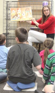 At Chuckatuck Library on Wednesday, Shawna LoMonaco, library assistant for Youth and Family Services, reads to a group of 9- through 12-year-olds from Rivers Bend Academy, which caters to autistic children.