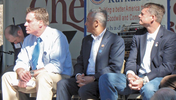 U.S. Senator Mark Warner, Congressman Bobby Scott and state Delegate Rick Morris sit onstage at the Shad Planking in Wakefield on Wednesday.
