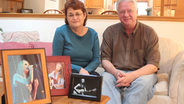 Jan and Bob Kelly, pictured inside their Smithfield home, are obviously immensely proud of their daughter, Bria Kelly, a contestant on NBC’s “The Voice,” framed photographs of whom rest on the coffee table.