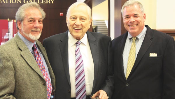 During Thursday evening’s reception in his honor, at the Suffolk Center for Cultural Arts, Suffolk First Citizen Robert W. “Bobby” Harrell Jr. smiles for the camera with Tim Early, left, and Tim Harschutz, right.