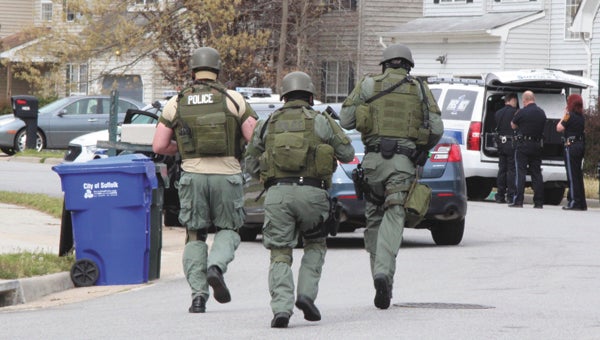 The Suffolk Police SWAT team heads toward a home on Woods Parkway. The situation ended peacefully several minutes after their arrival.