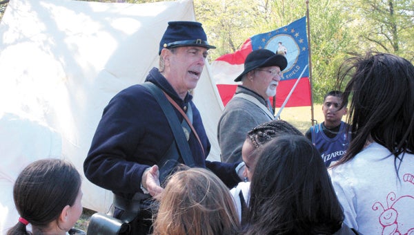 At Oakland Elementary School on Wednesday, Civil War re-enactors Jim Mayo and Wayne Taylor show Ashley Christopher’s fifth-grade class the often-harsh realities of life in a Civil War camp.
