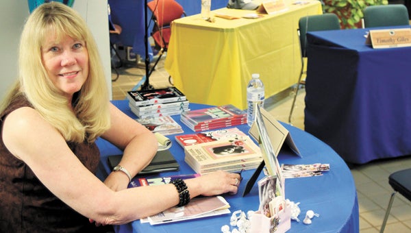 Phyllis Johnson, a Suffolk native, signs books during the Paul D. Camp Community College Literary Club’s fifth annual literary festival Friday at the Hobbs Suffolk campus.