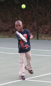 Seven-year-old Malechi Thomas participates Wednesday in the Suffolk tennis program at the Howard Mast Tennis Complex.